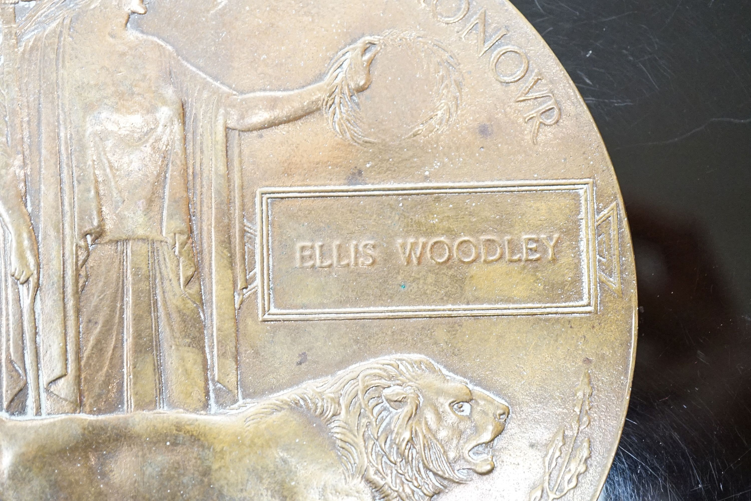 A WWI bronze death plaque to Ellis Woodley